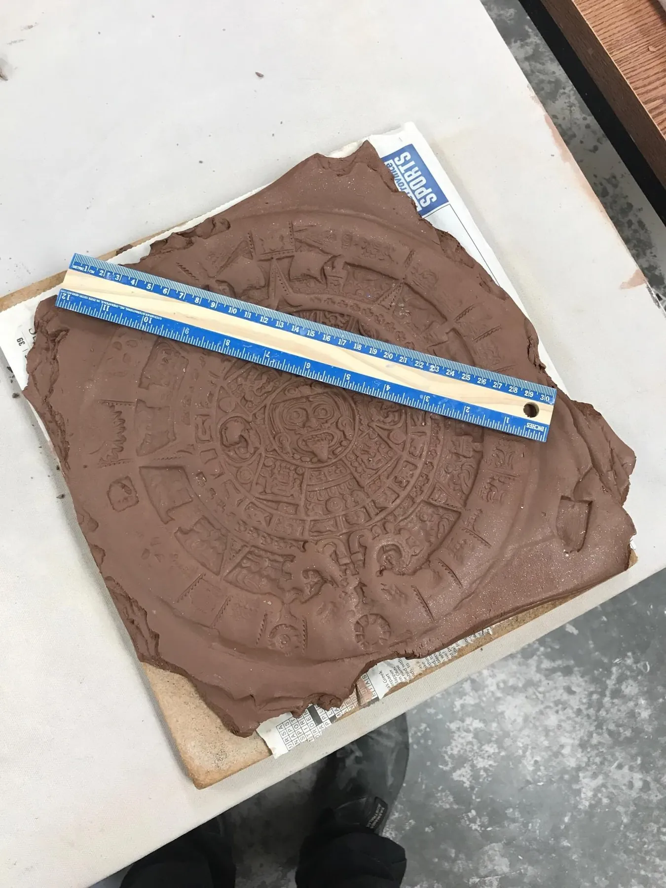 Rolled clay slab with a ruler in the Hand Eye Ceramics studio