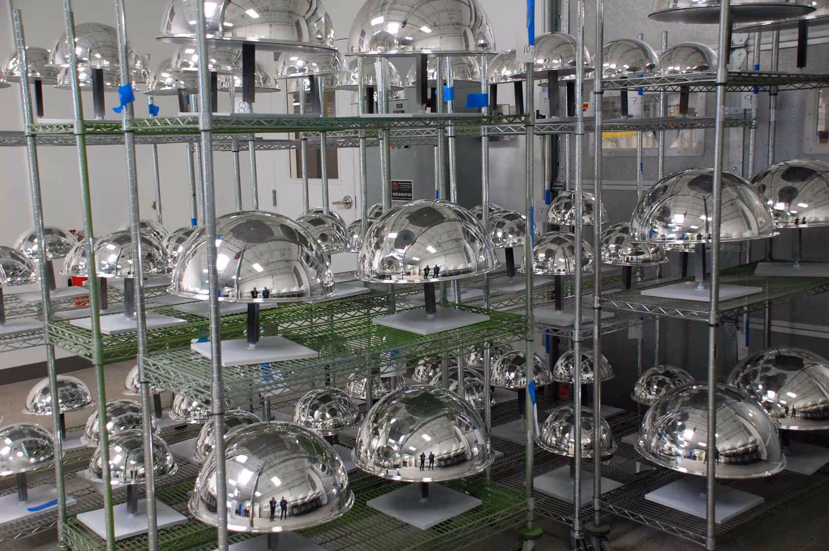 A room full of acrylic jingle ball display pieces drying after being painted