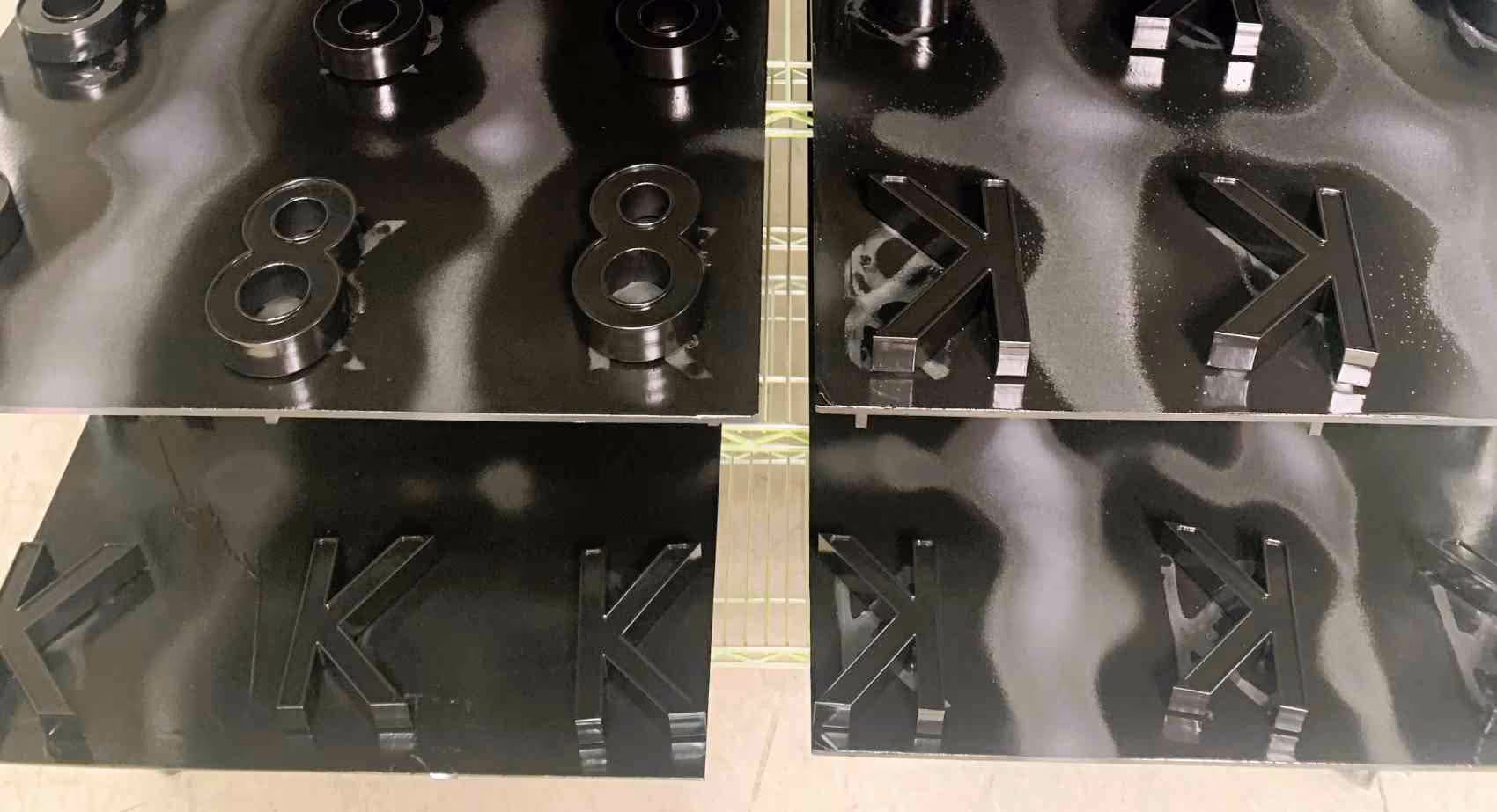 Dimensional letters drying after being painted