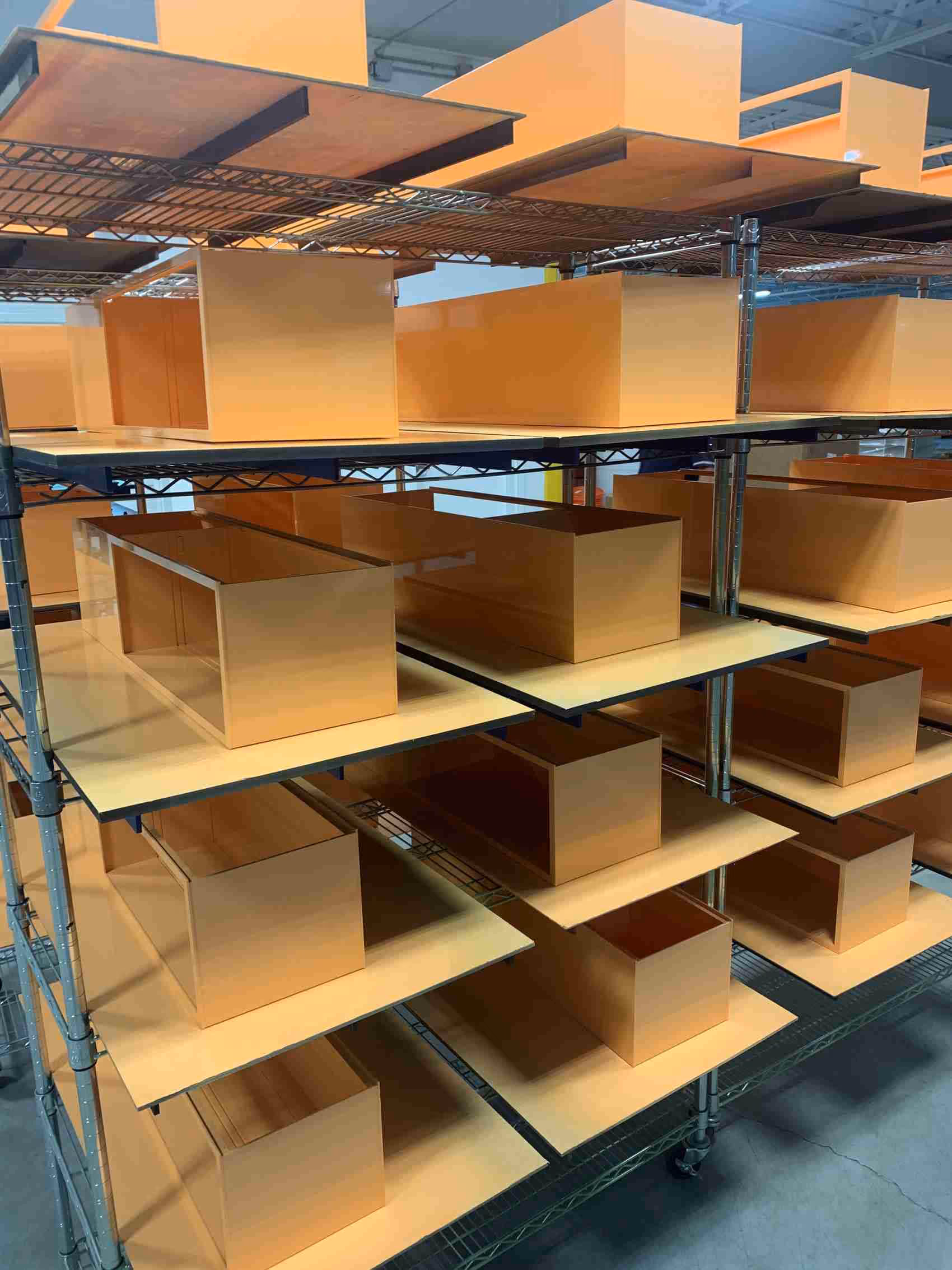 Rows of display elements drying on racks after being painted.