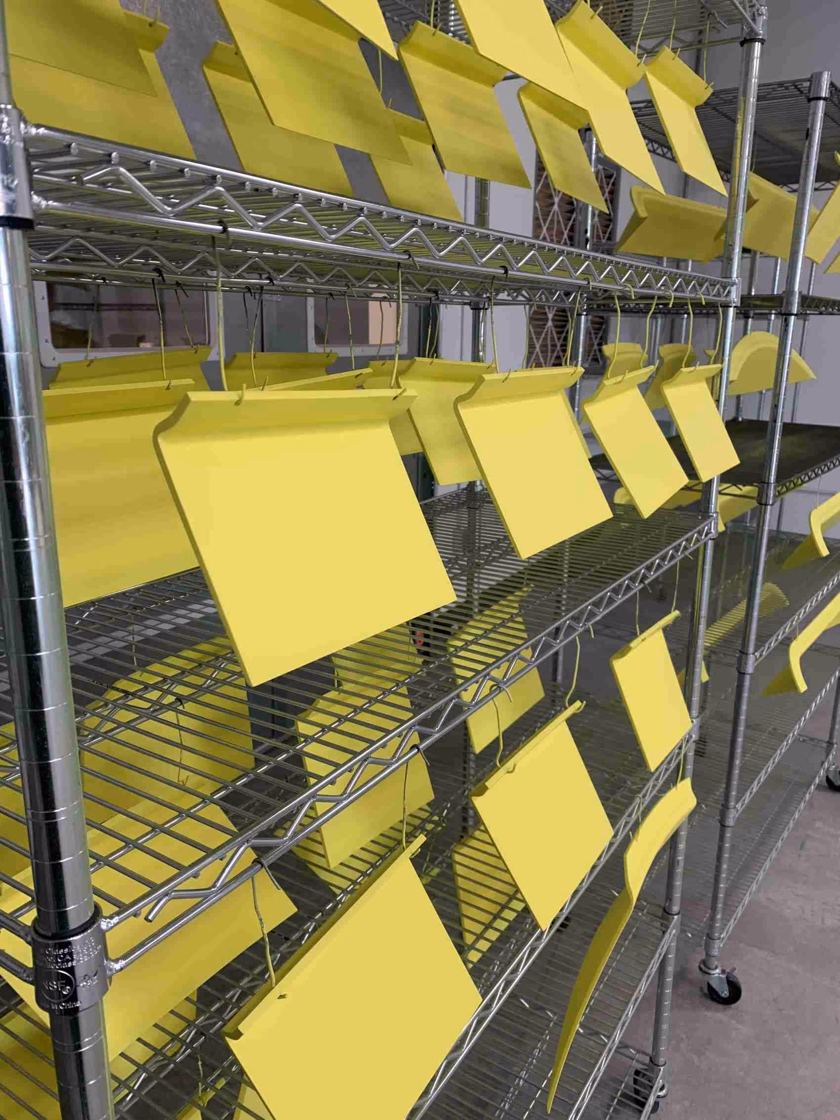 Rows of display elements drying on racks after being painted.