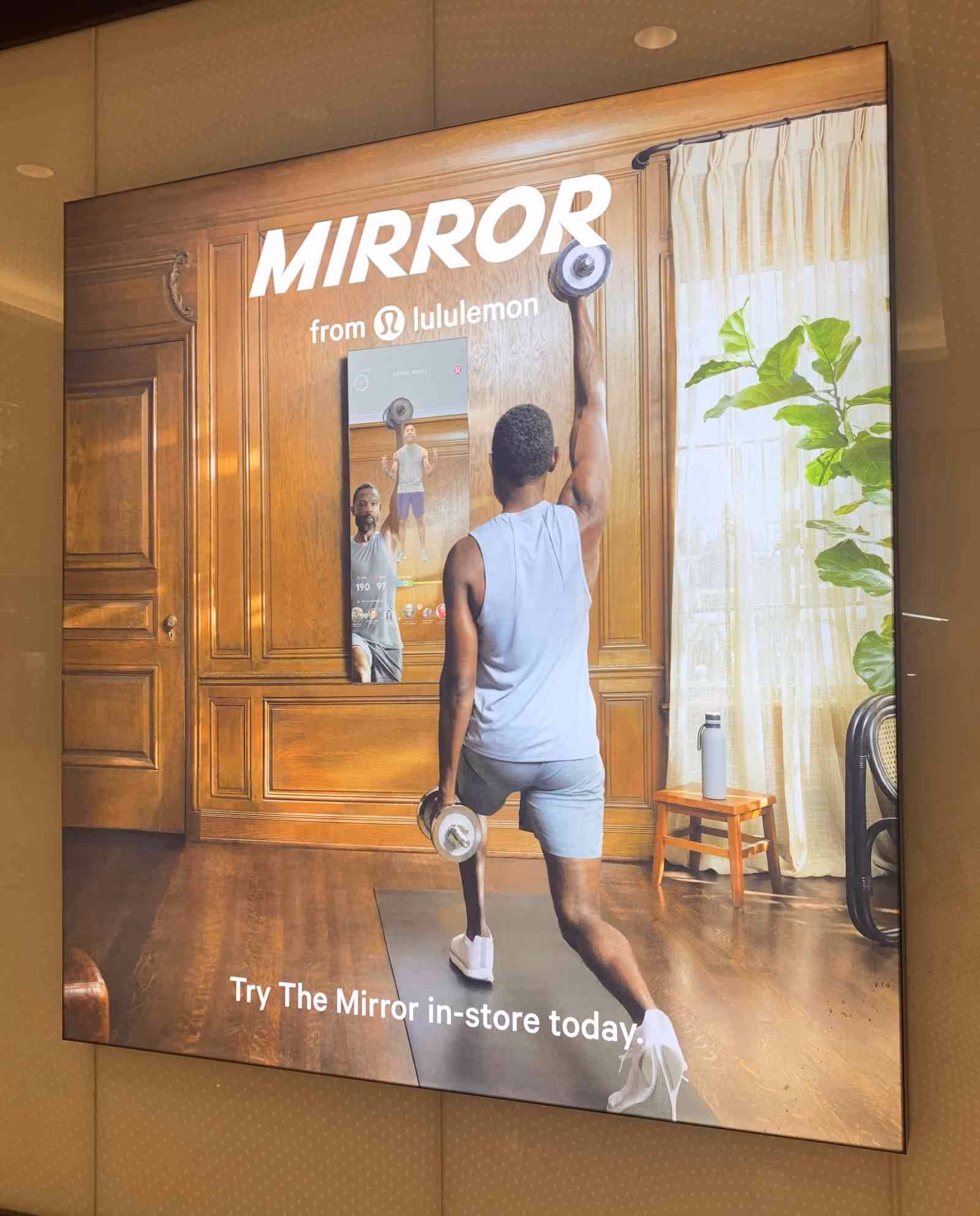 Lululemon Mirror product with a person exercising in front