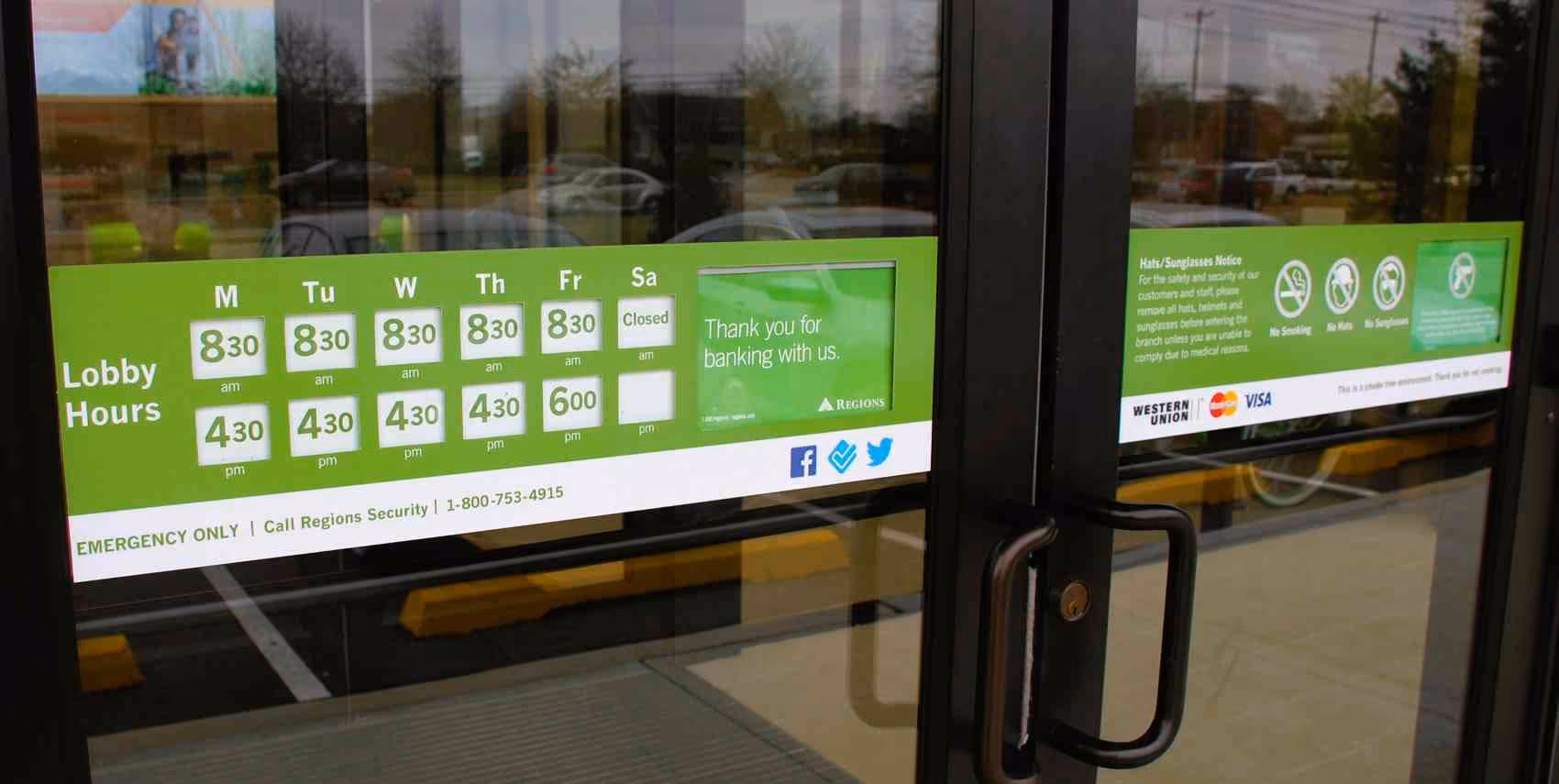 Bank front doors with signage for Open hours