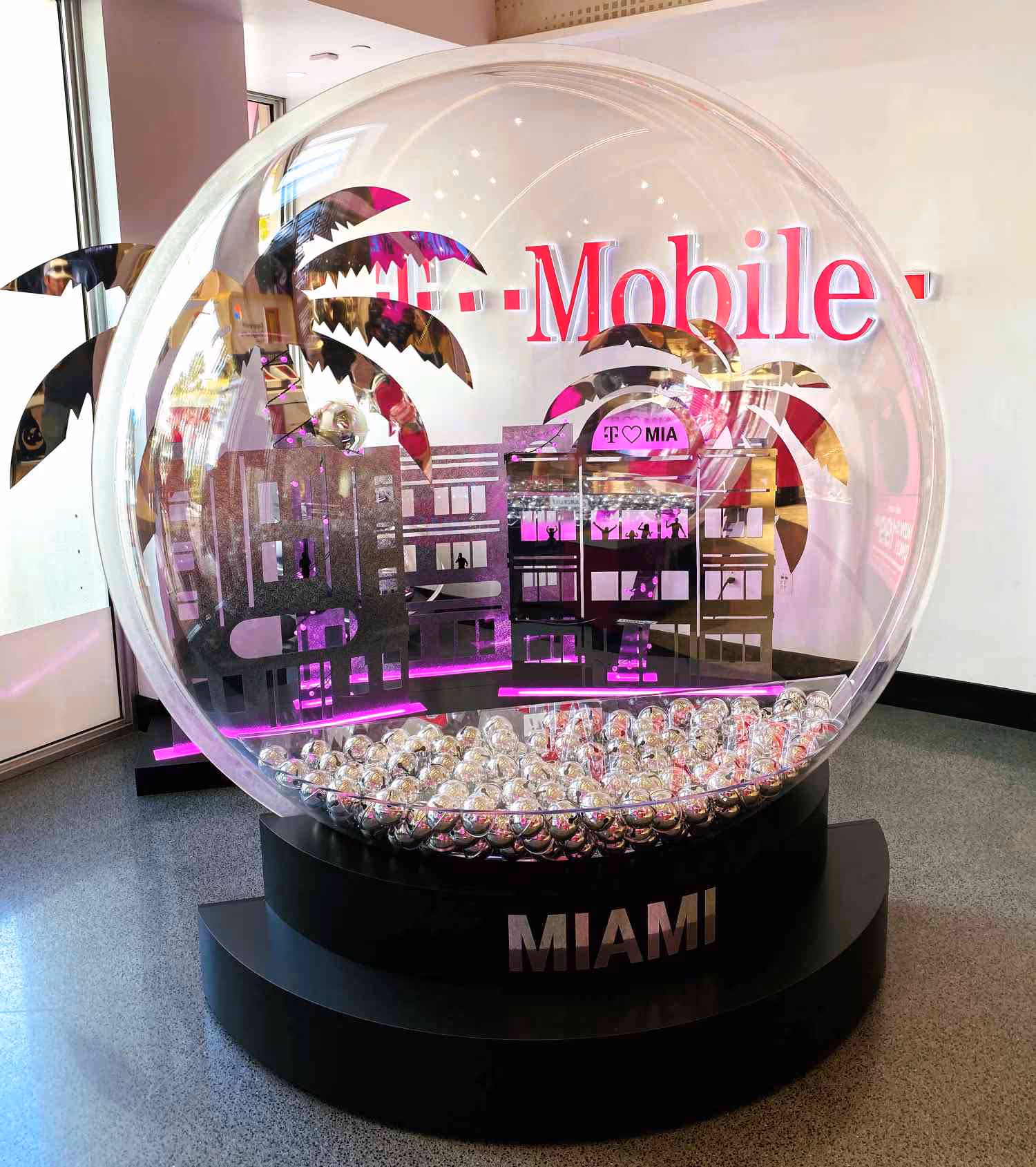 A large-scale retail display of a snow-globe; T-Mobile