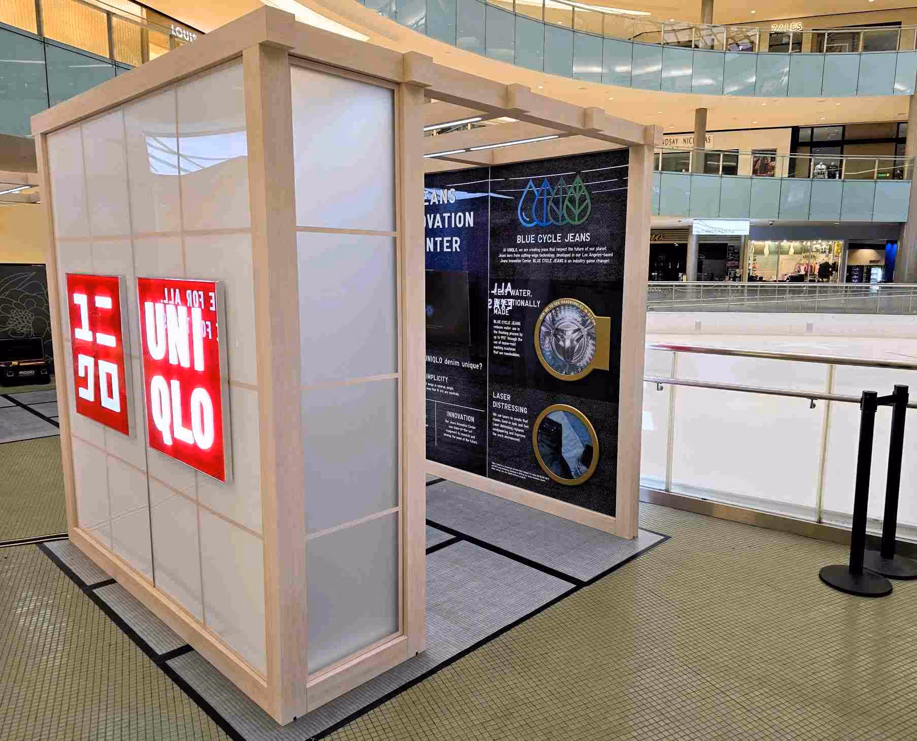 A Uniqlo pop-up display exterior inside a shopping mall