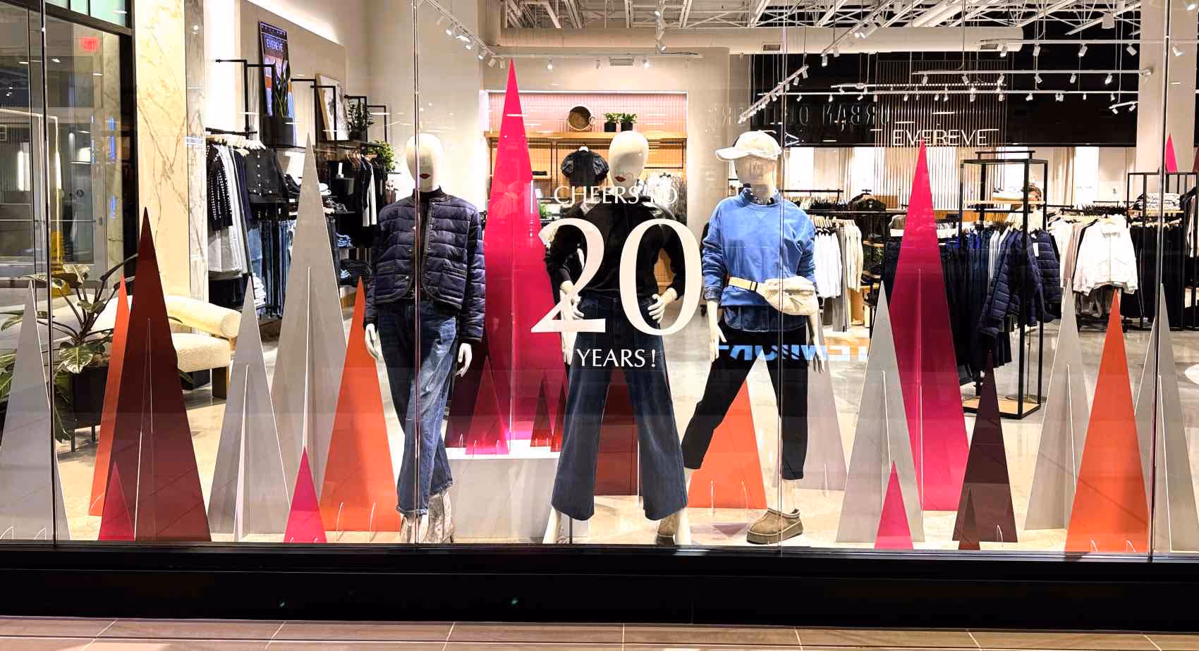 Custom retail displays: Colorful pine tree displays made from recycled acrylic in a retail window