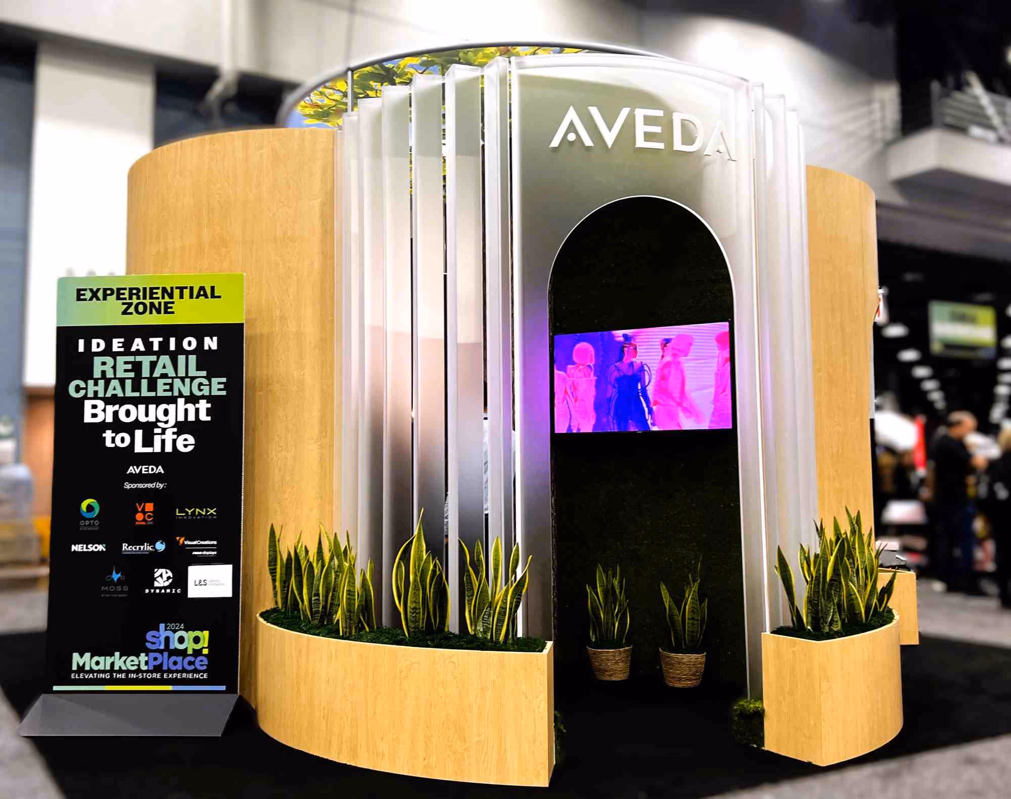 An Aveda pop-up store with an entrance made from Recrylic recycled acrylic and a custom sign with dimensional letters