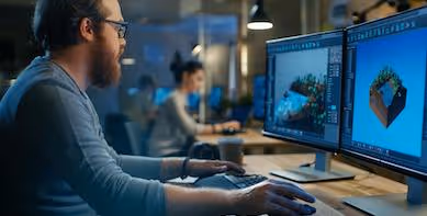 A graphic designer working on 3D graphics on his computer