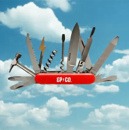 EP+Co branded Swiss Army knife in the foreground. Blue sky and clouds in the background.