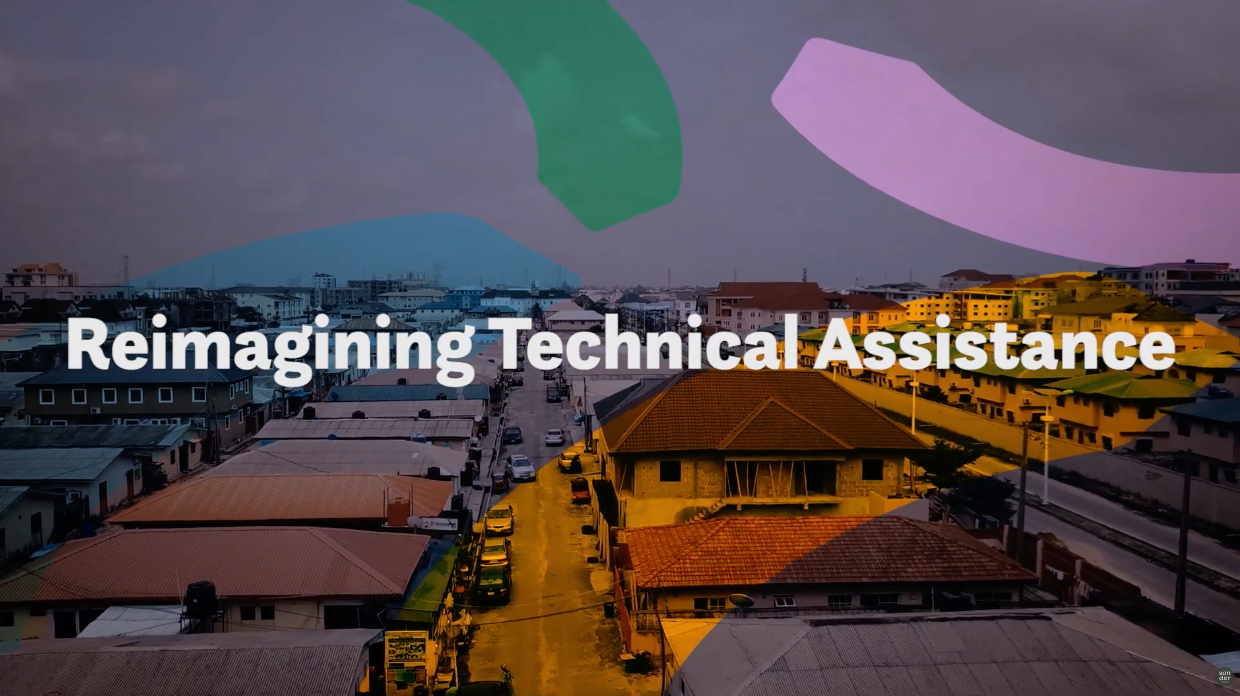 Aerial view of a city street with buildings and cars, overlaid with colorful abstract shapes and the text 'Reimagining Technical Assistance'.