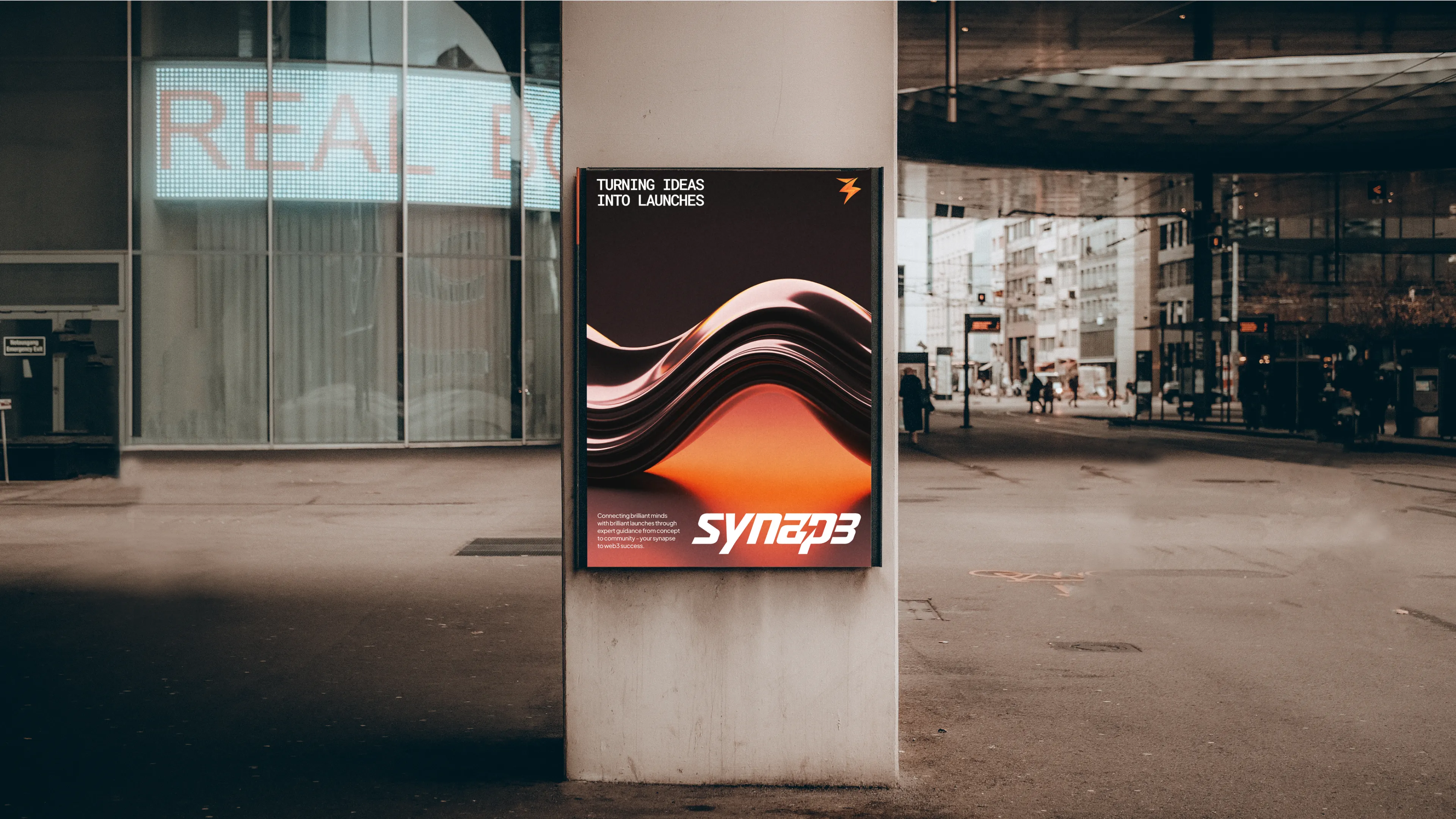 A poster on a pole in front of a building.
