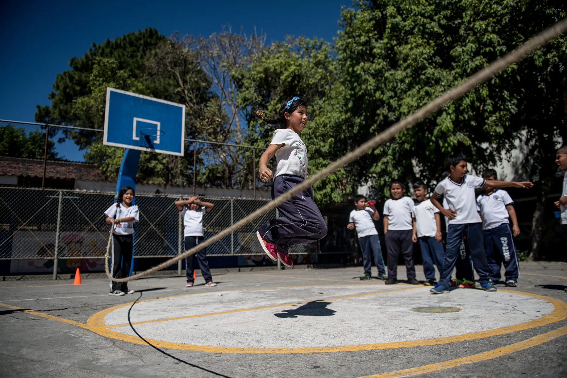 Students jumping rope in a playground. Photo courtesy of Neil Brandvold and Valentina Pereda for Glasswing International 