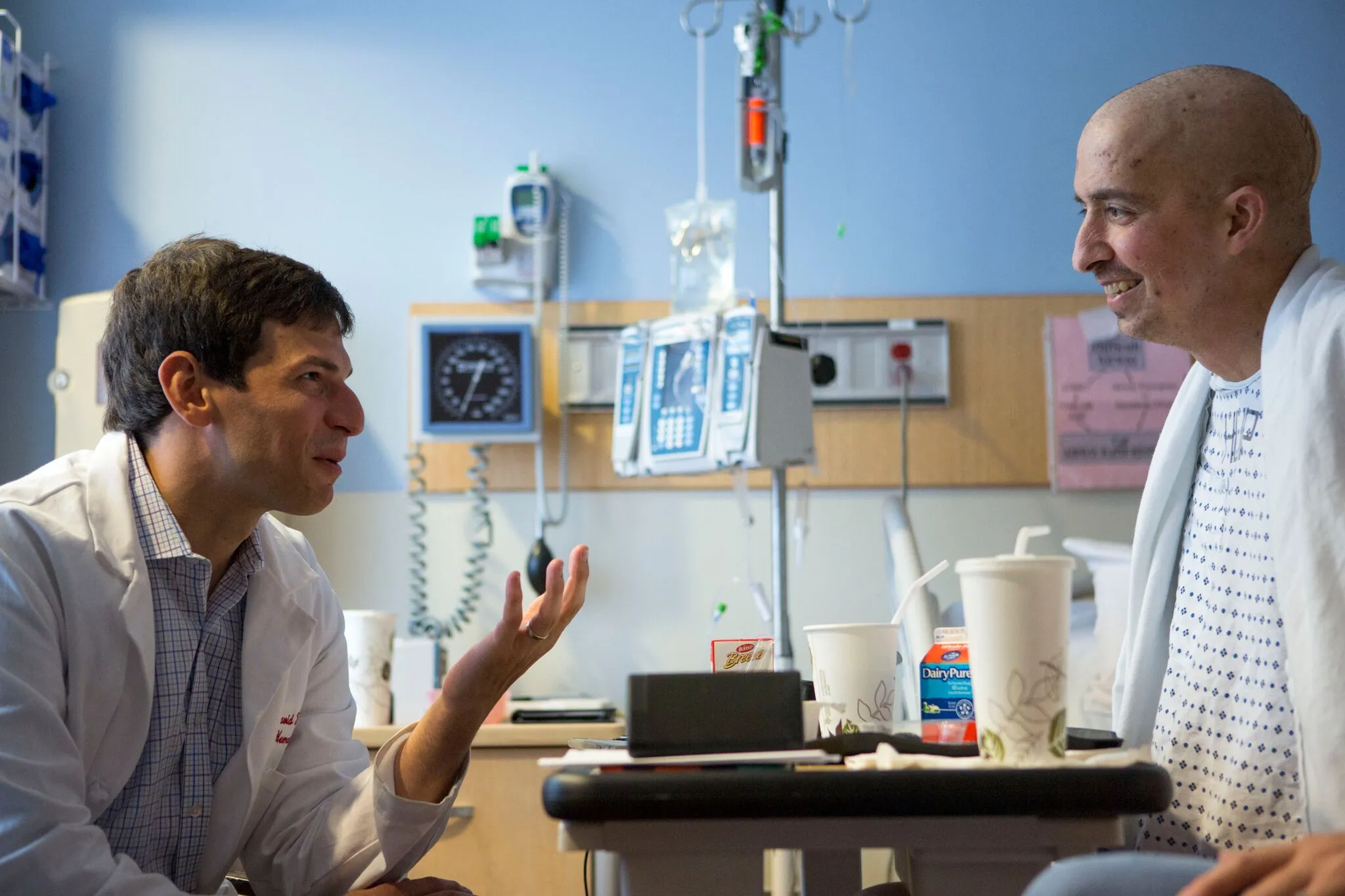 Doctor and patient smiling in hospital room
