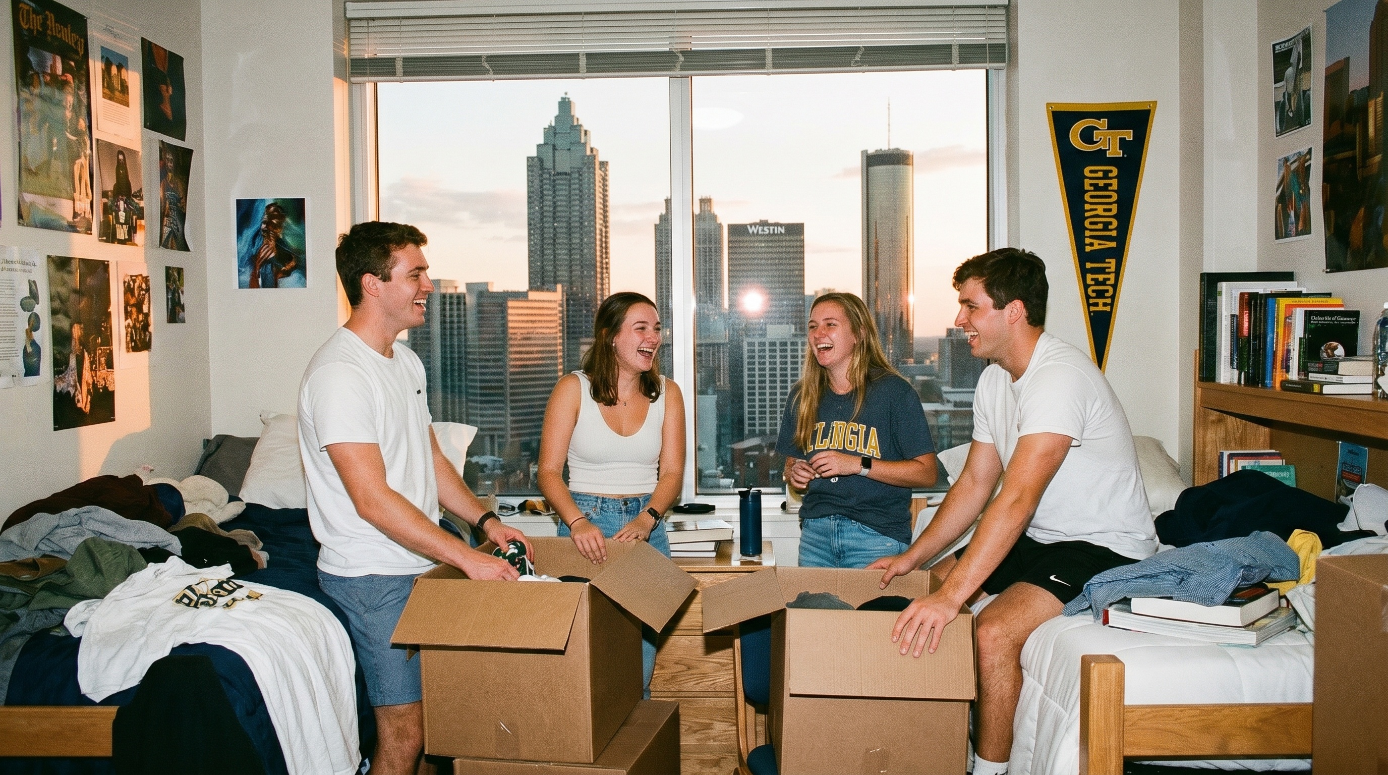 college students packing boxes in dorm room with Atlanta skyline visible through window