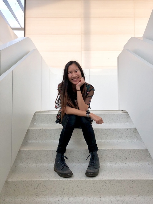 Women sitting on steps and smiling at the camera