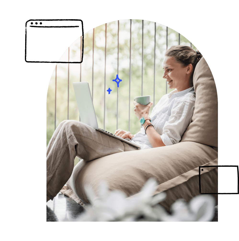 Adult lounges comfortably outside their home while using a laptop.