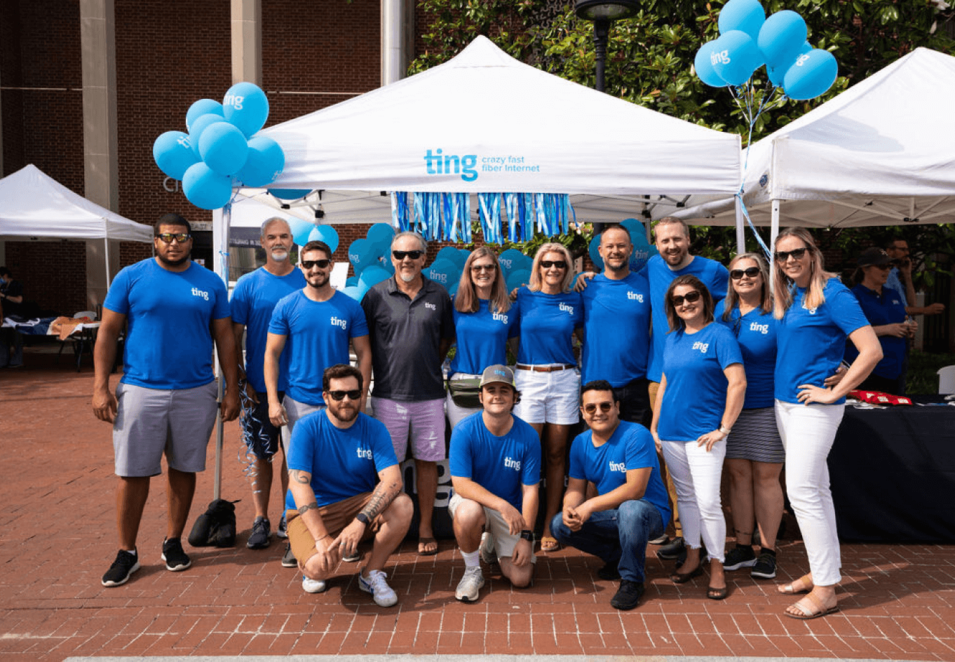 The Ting Internet team gathered outside wearing blue Ting shirts.