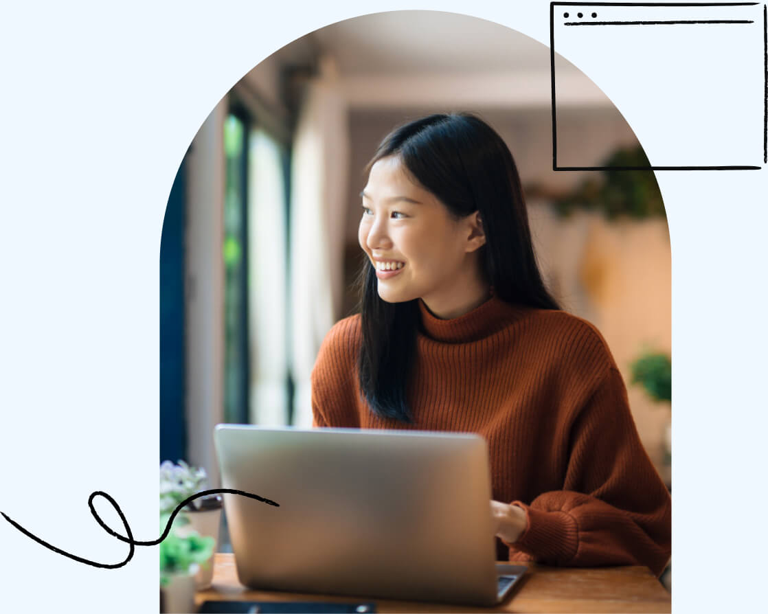 A young adult happily using a laptop over a Wi-Fi connection.