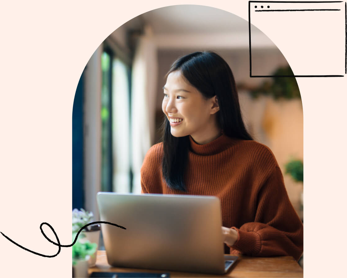 A young adult happily using a laptop over a Wi-Fi connection.