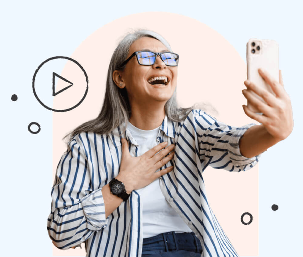 A woman using an iPhone, laughing