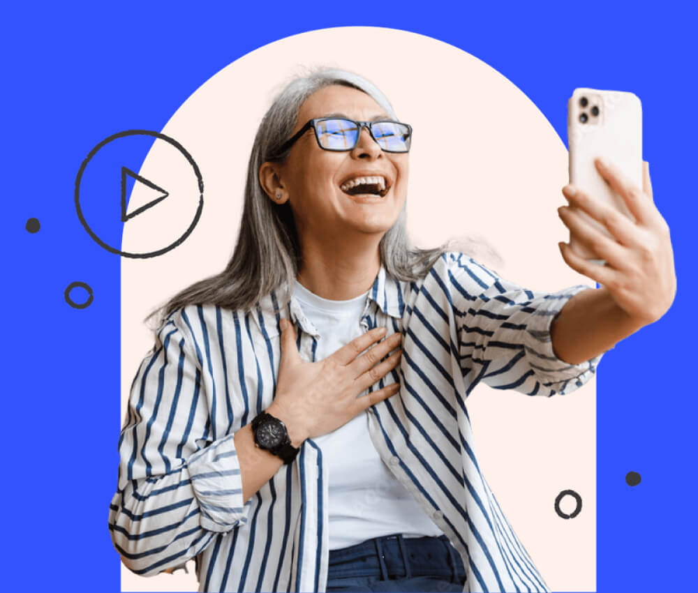 A woman using an iPhone, laughing