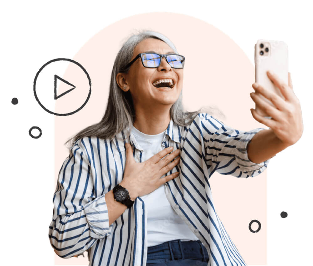 A woman using an iPhone, laughing