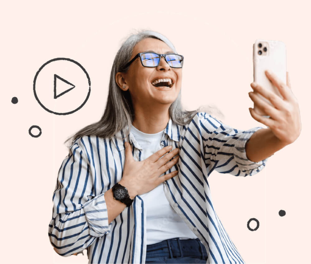 A woman using an iPhone, laughing