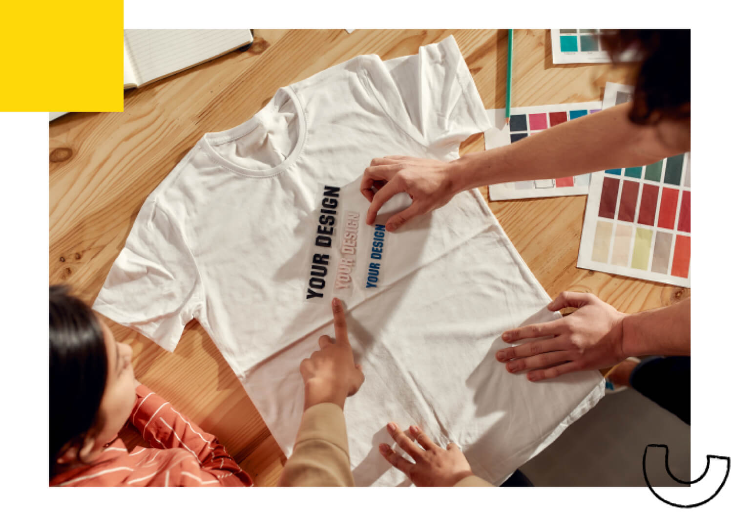 A overhead shot of people working on a custom shirt