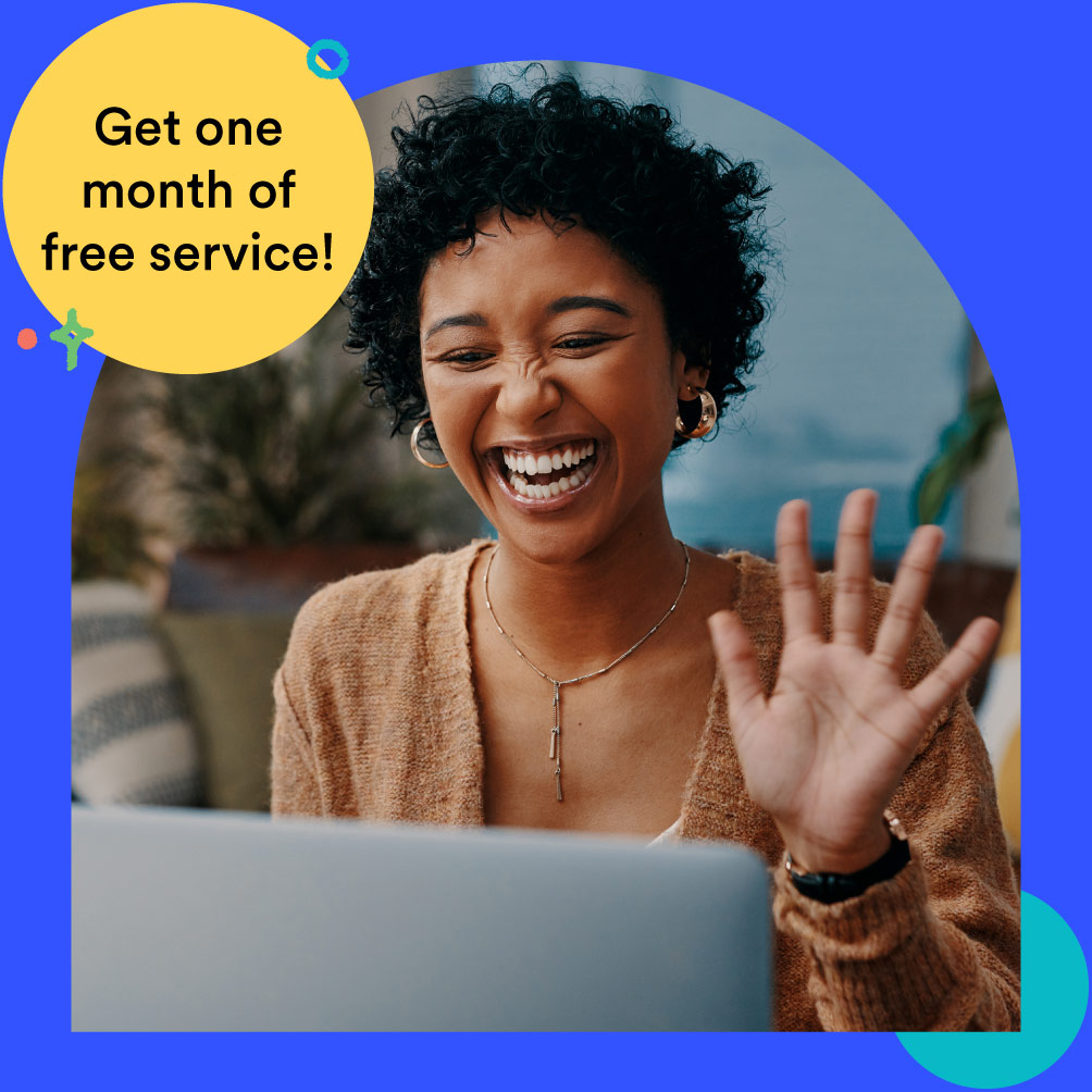 Woman with laptop smiling and waving