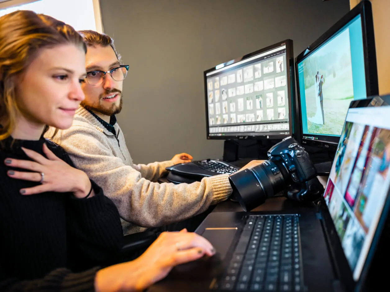 Two content creators behind numerous screens and devices connected to the internet.