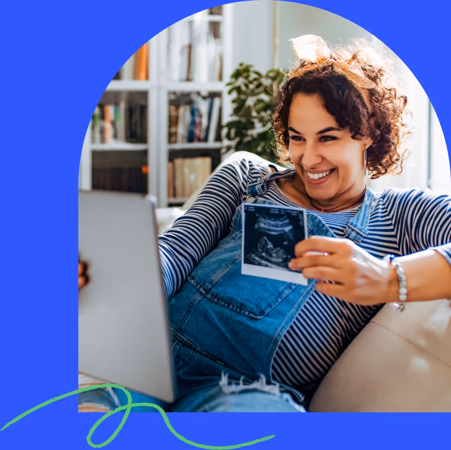 A woman sharing news she is pregnant over video chat