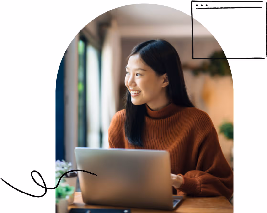 A young adult happily using a laptop over a Wi-Fi connection.