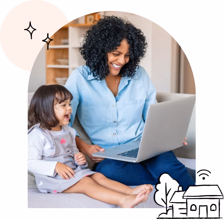 A mother and a daughter sit on the computer together