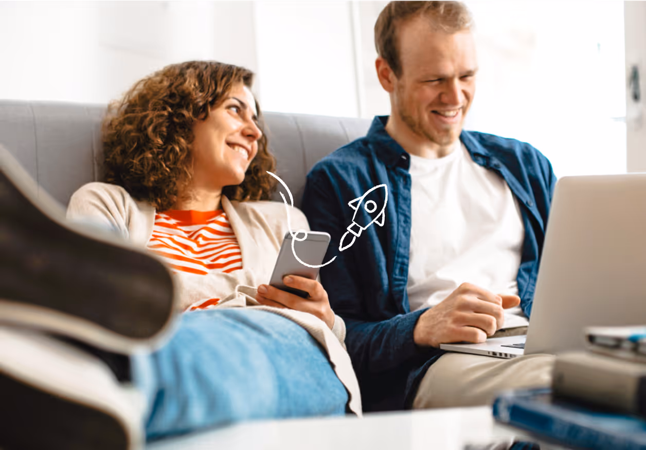 A couple working on smart devices on the couch