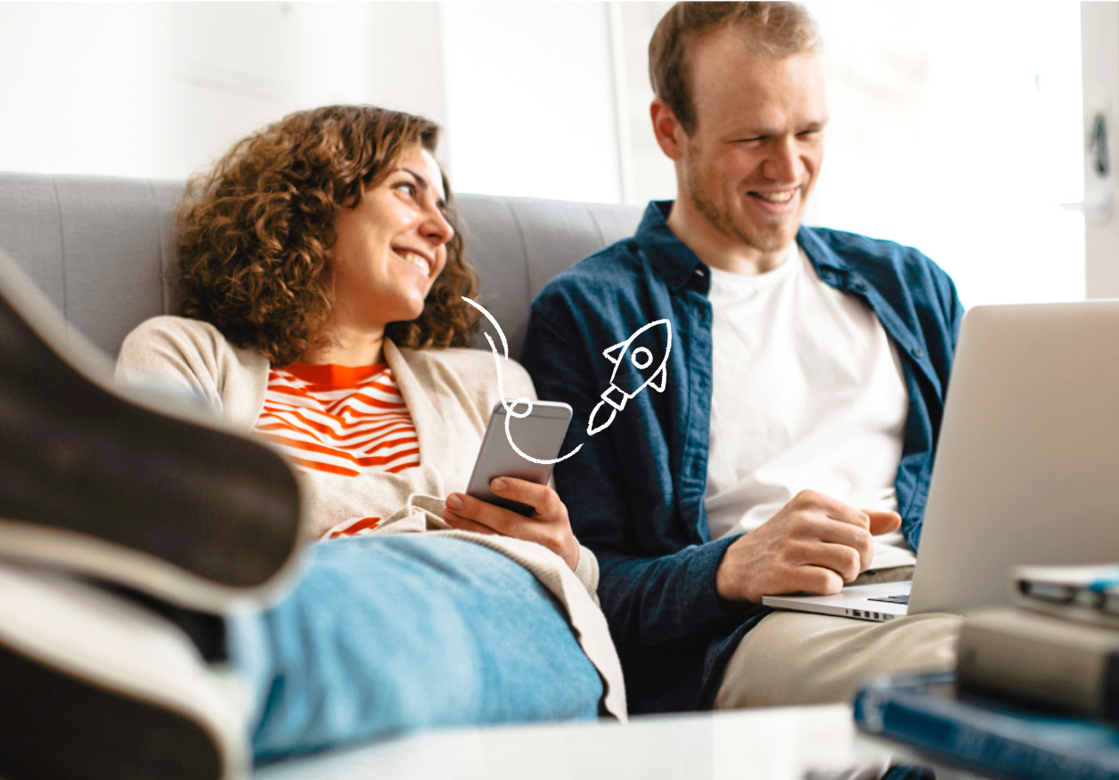 A couple working on smart devices on the couch