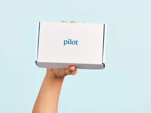 Hand holding a pilot product box