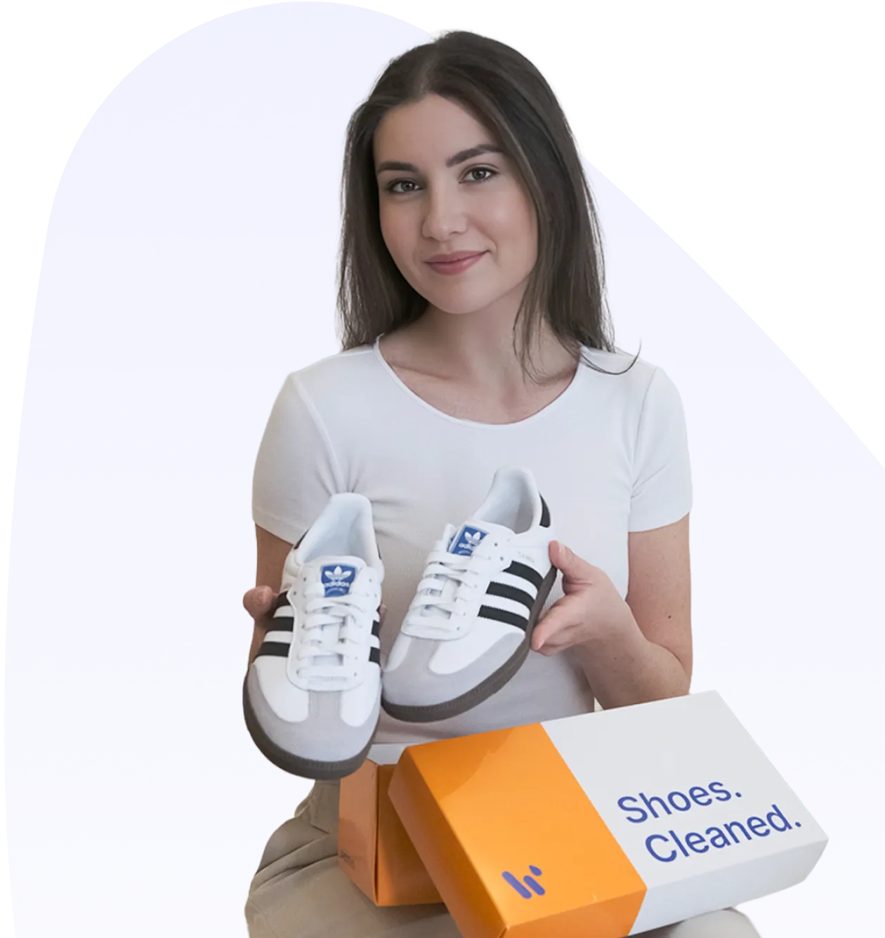 a woman holding a pair of shoes