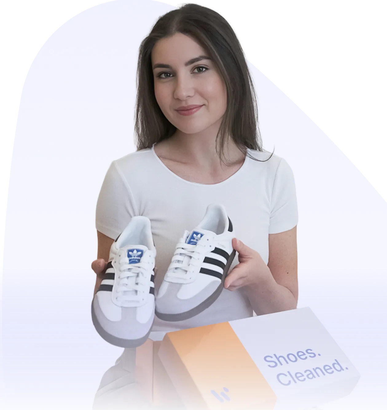 a woman holding a pair of shoes