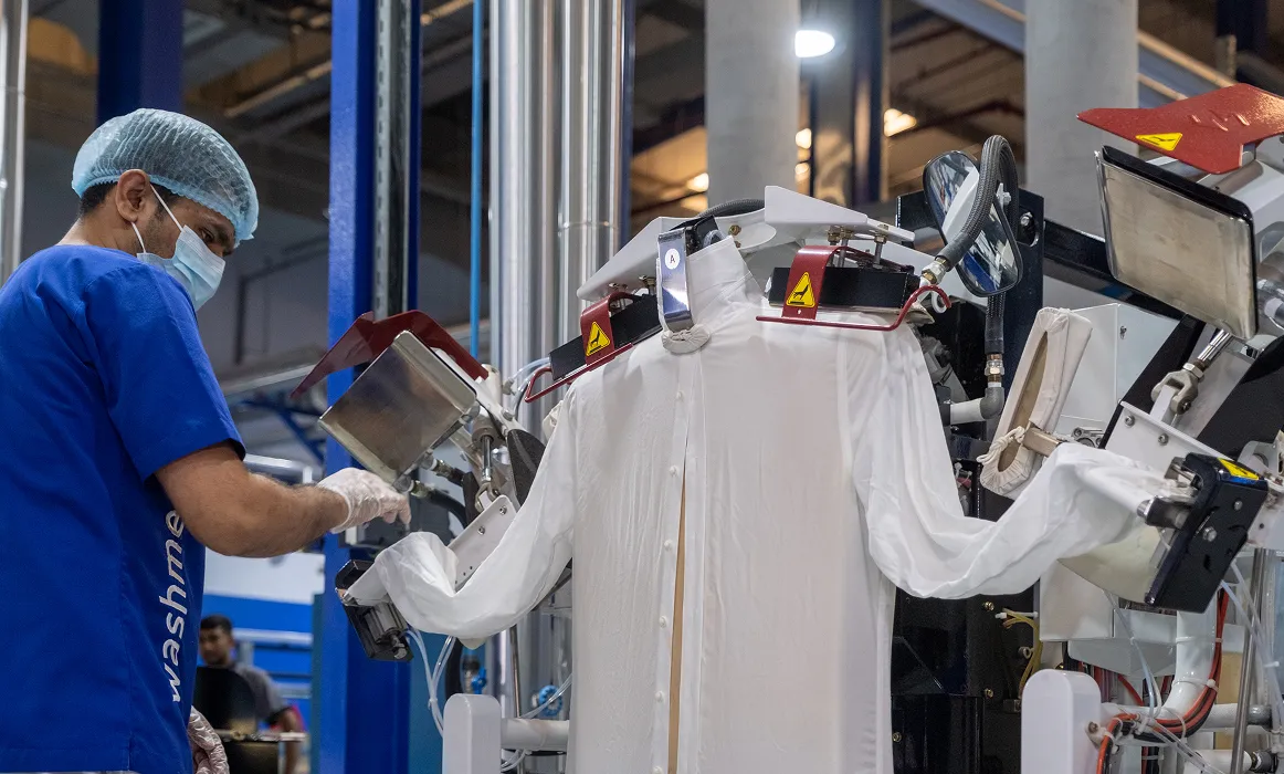 a man wearing a mask and gloves working on a machine
