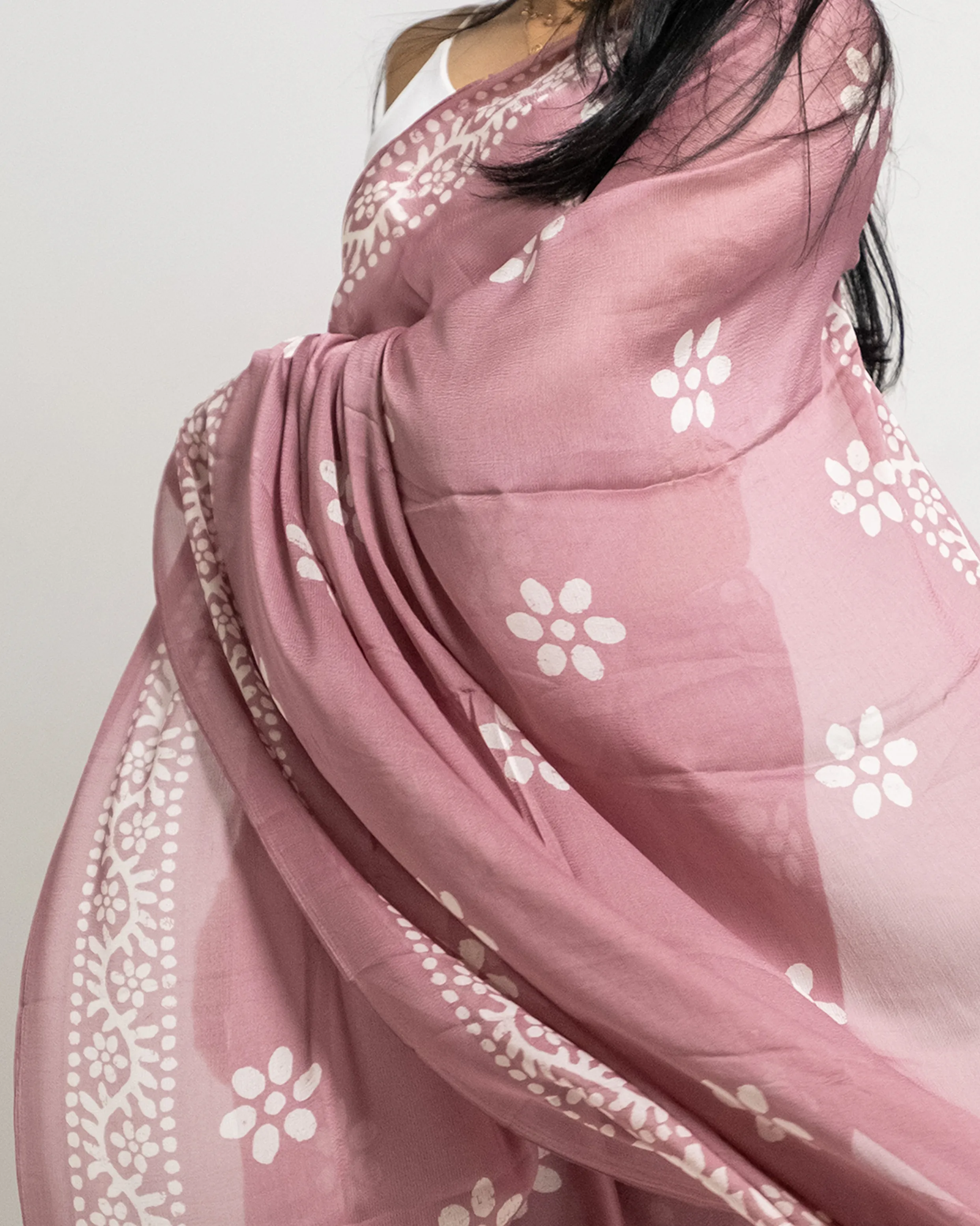 a woman wrapped in a pink scarf