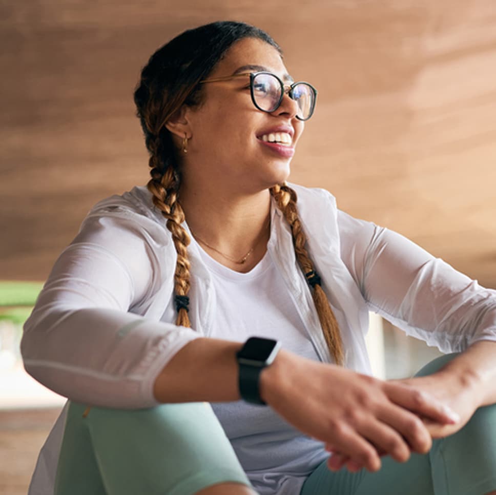 A woman posing for a picture, looking to the right and smiling