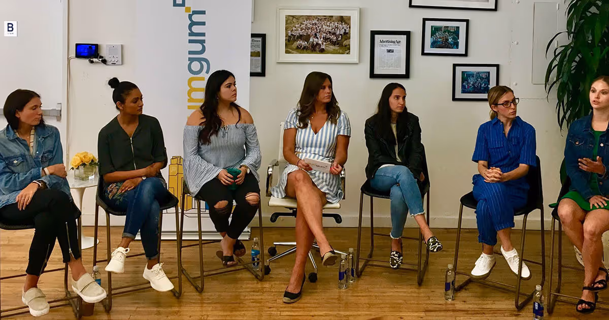 Photograph of seven women having a discussion