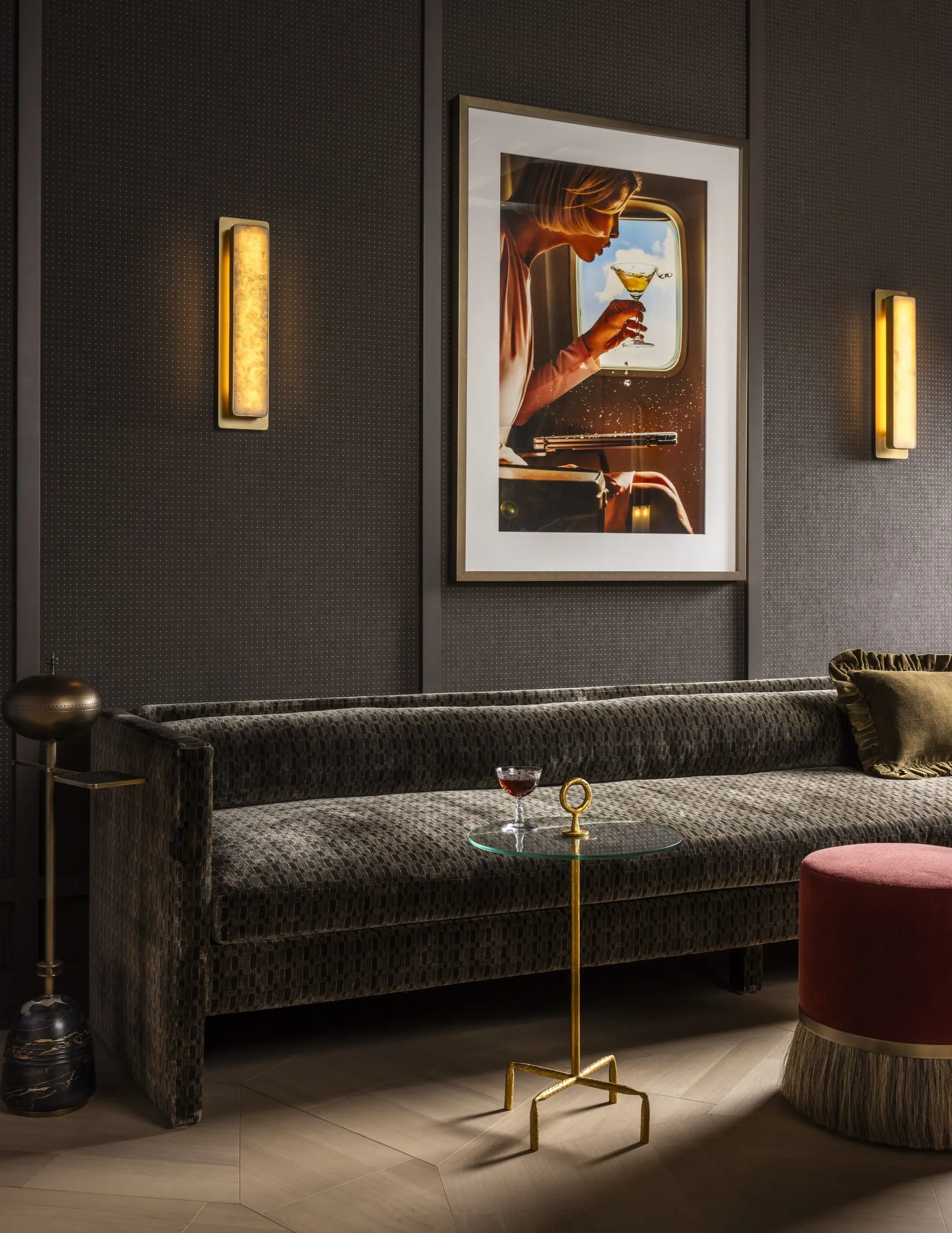 Moody den lounge with custom sofa and gallery wall art