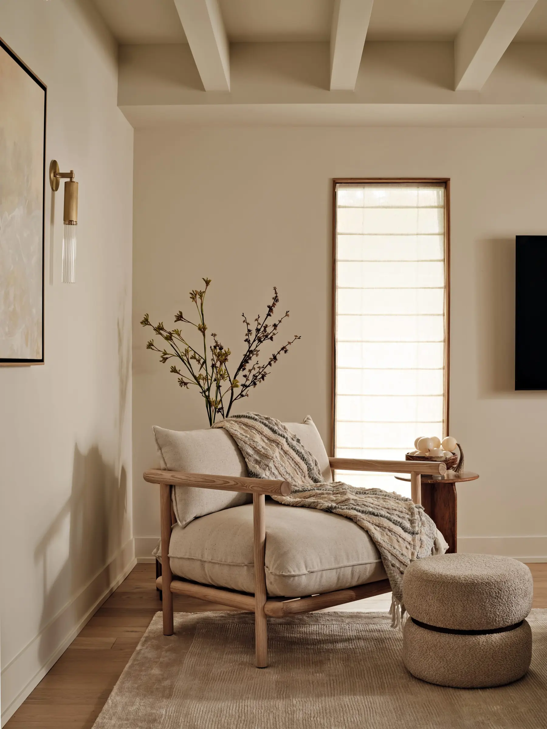 Wood-framed lounge chair in a sunlit reading nook, upholstered for lingering