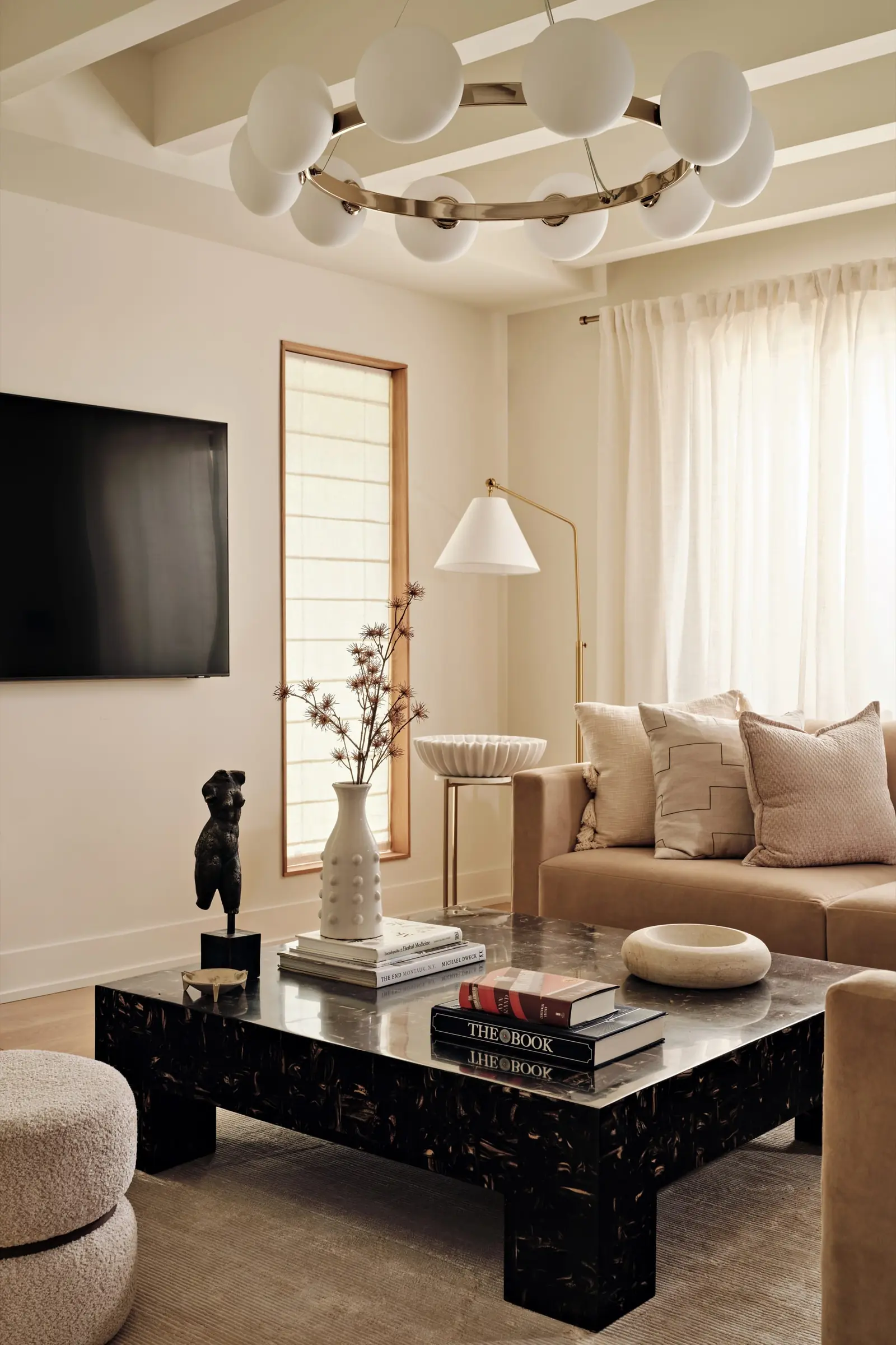 Living room with sculptural stone coffee table and wide-plank American oak floors