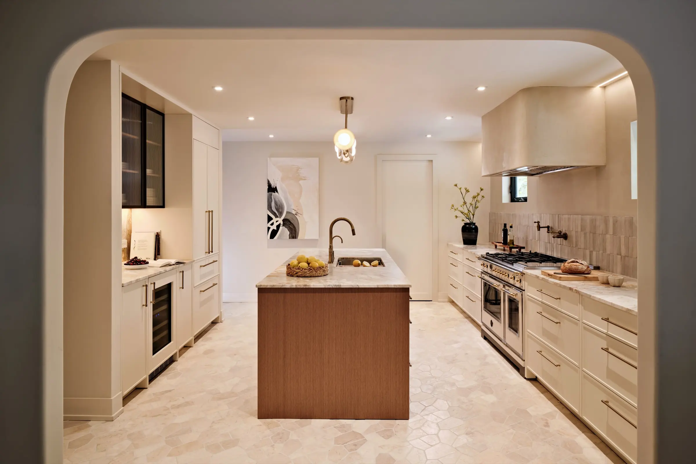 Kitchen with honed marble countertops and full-height cabinetry