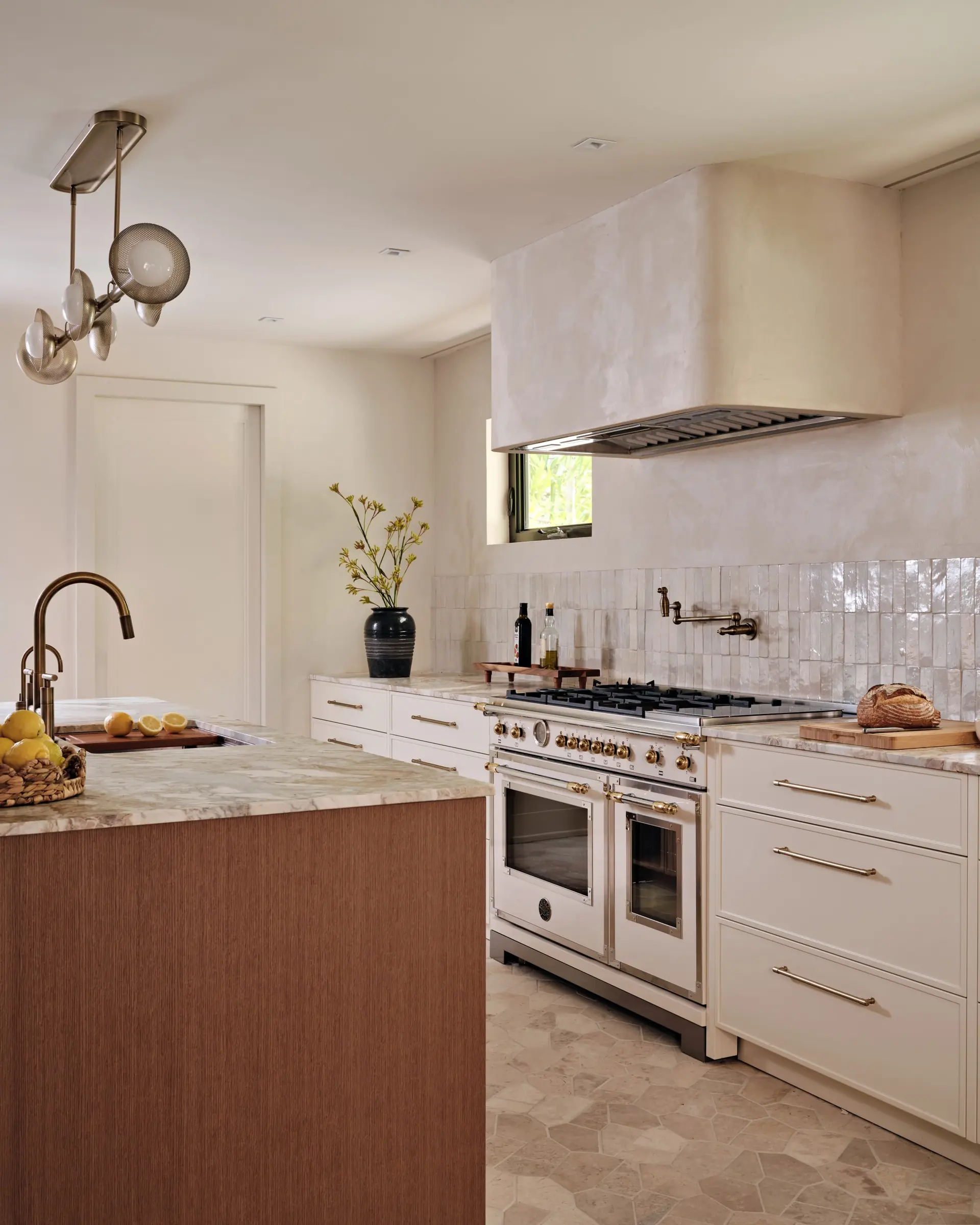 KKitchen with honed marble countertop, handmade ceramic tile backsplash, and professional range