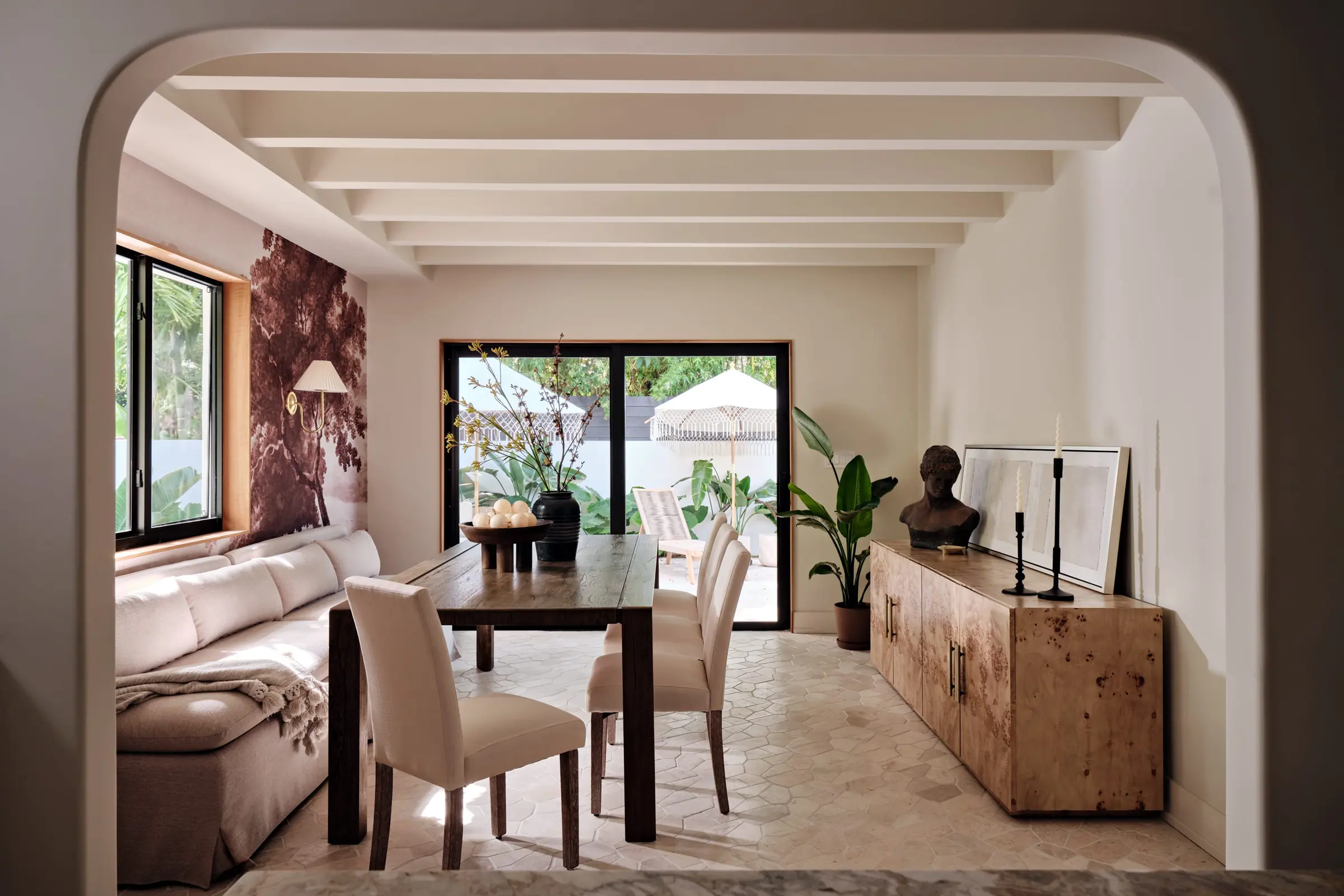 Dining room with opened beamed ceiling, opening onto the rear yard