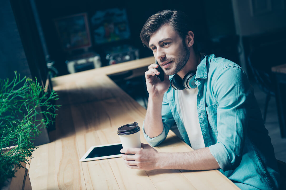 Man at a cafe and on the phone