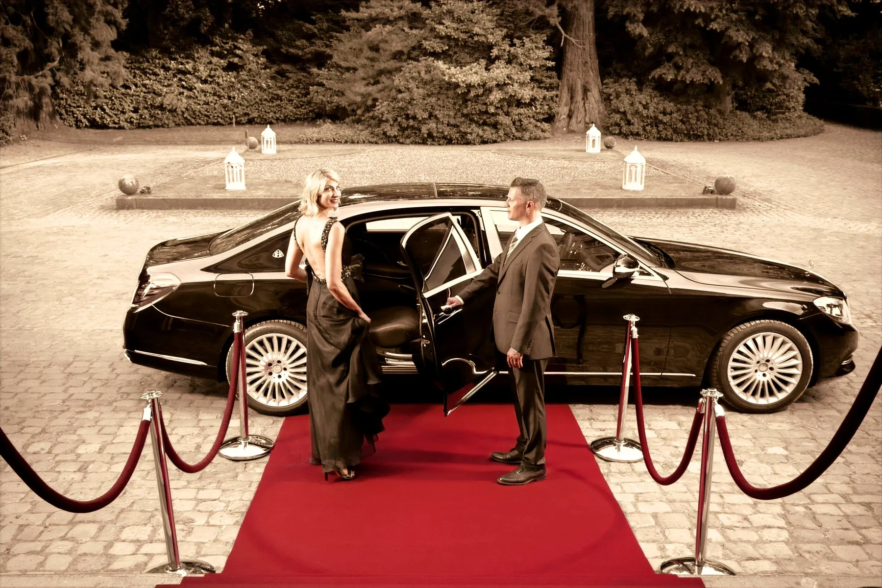 A chauffeur-driven car at a red-carpet evening